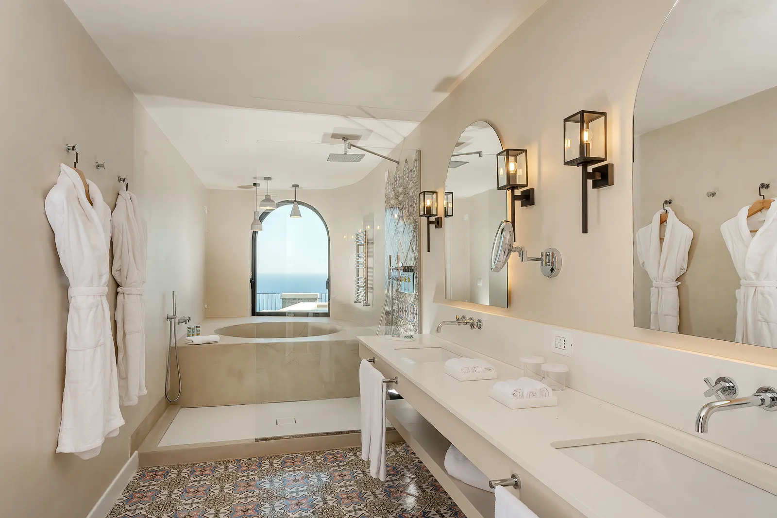 Bathroom at Furore Grand Hotel with bathtub, walk-in shower, double vanity and a sea-view window